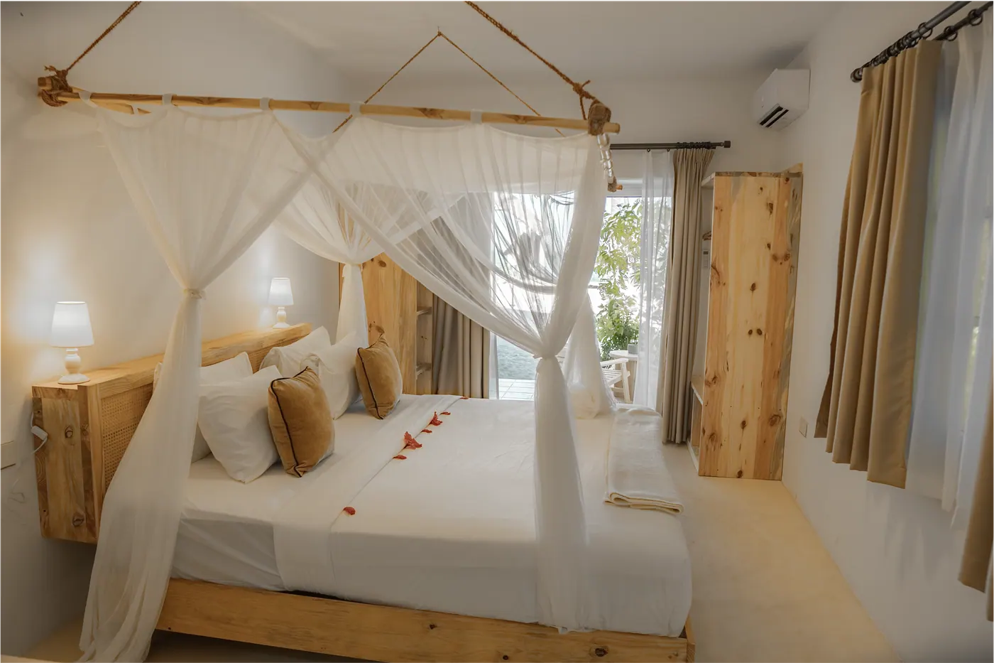 Bright boutique hotel room with canopy beds