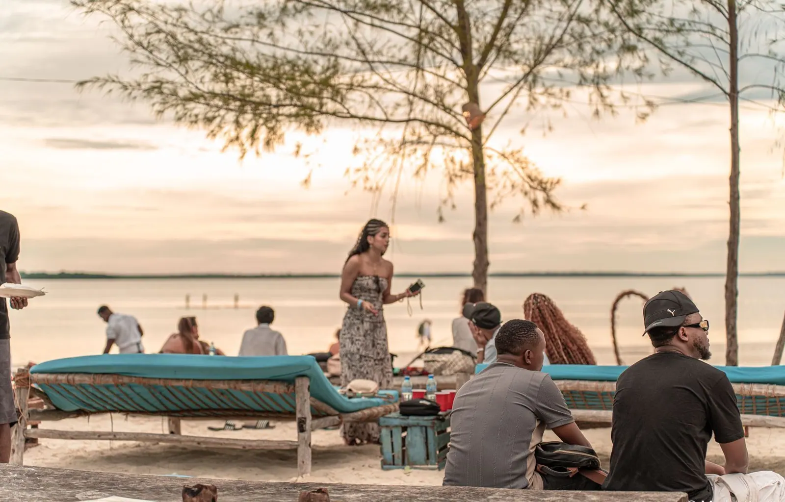 Guests on the beach at Kanga Fest 2025 under an evening sky